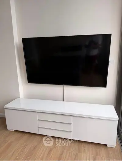 Modern living room with sleek white TV stand and mounted flat-screen TV