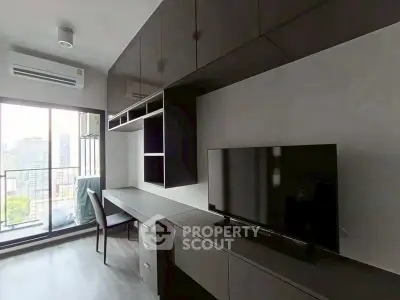 Modern living room with sleek furniture and city view balcony in high-rise apartment.