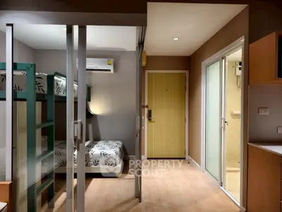 Modern compact apartment with bunk beds and sliding glass doors
