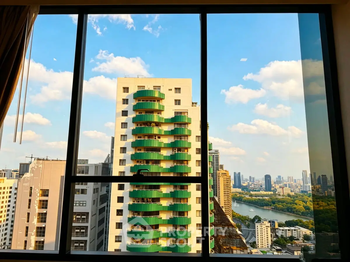 Stunning cityscape view from high-rise apartment window with vibrant skyline and river.