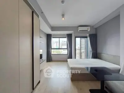 Modern studio apartment with city view, featuring sleek design and ample natural light.