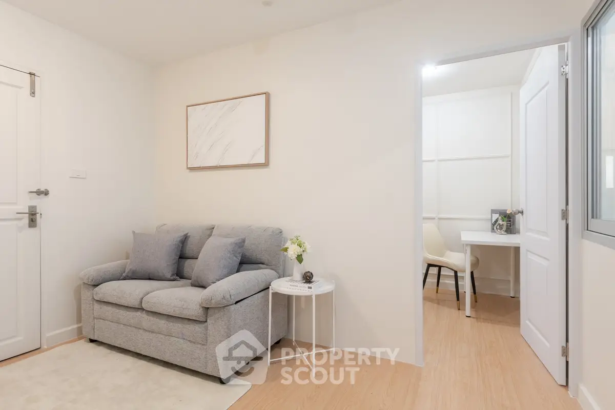 Cozy living room with modern decor and adjacent study area