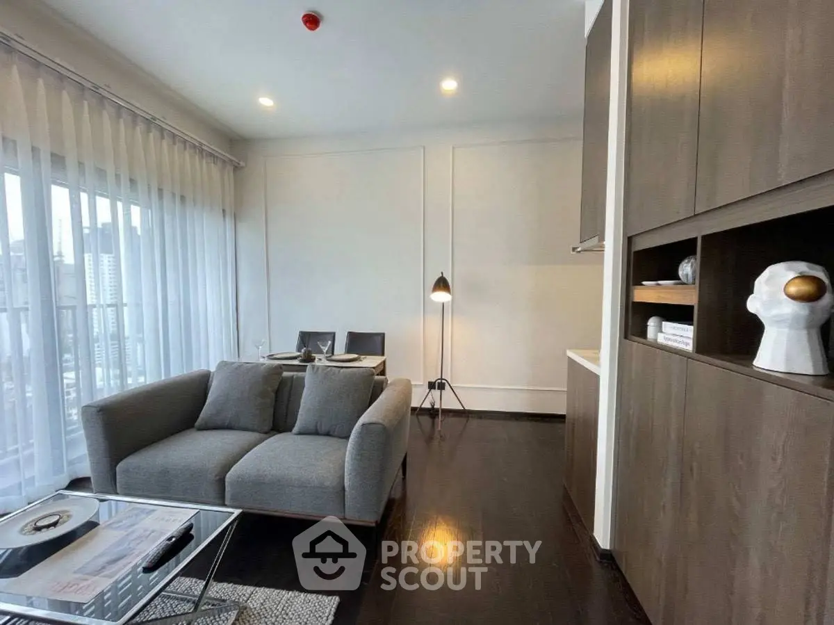 Modern living room with sleek furniture and city view, perfect for urban living.