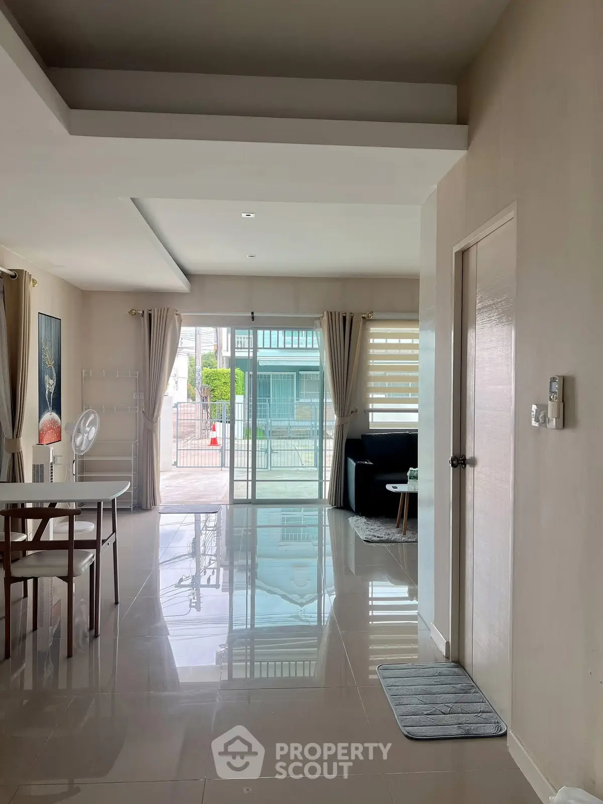 Spacious modern living room with glossy floors and large windows for natural light.