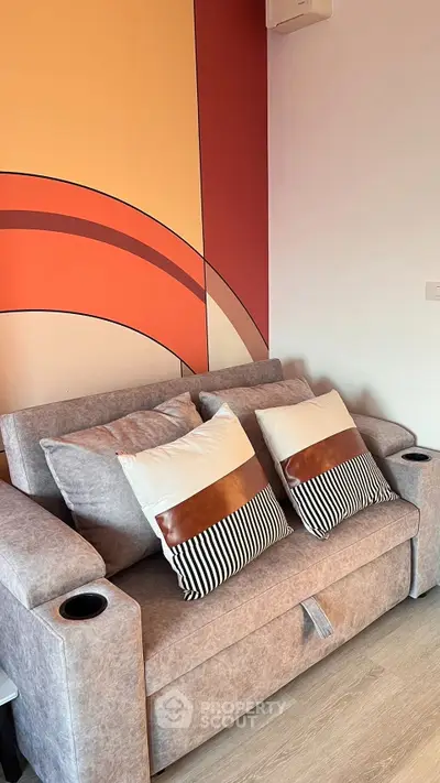 Stylish living room with modern sofa and vibrant wall art
