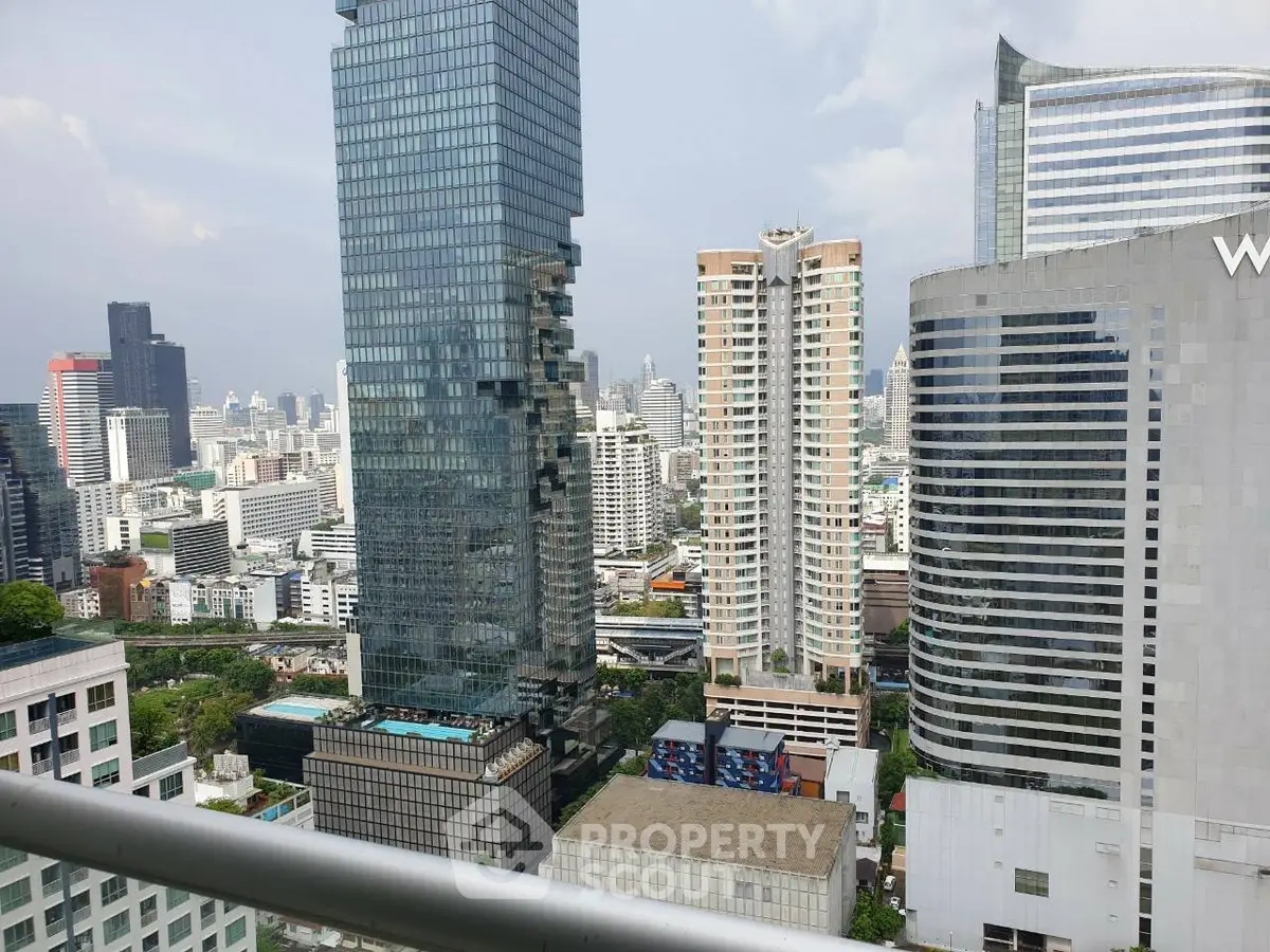Stunning cityscape view from a high-rise balcony showcasing modern skyscrapers and urban skyline.