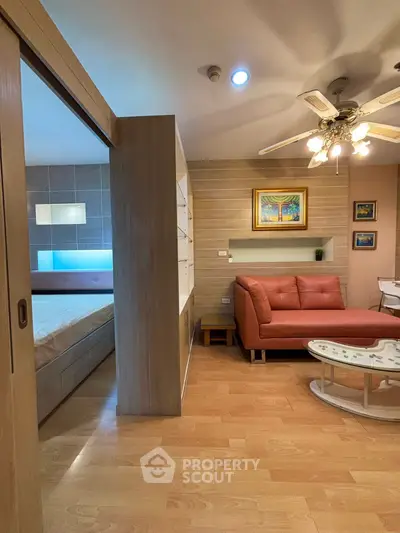 Stylish living room with modern decor and cozy seating area adjacent to bedroom.