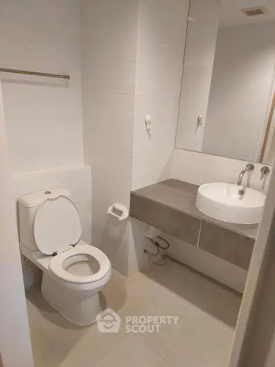 Modern bathroom with sleek white fixtures and minimalist design.