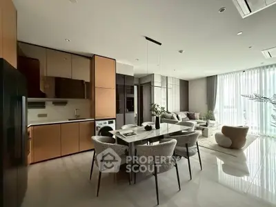 Luxurious modern open-plan living room with elegant dining area and sleek kitchen design.