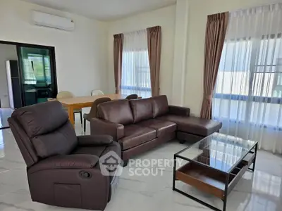 Spacious living room with modern furniture and large windows