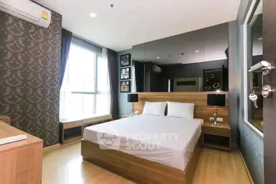 Luxurious modern bedroom with elegant decor and large window for natural light.