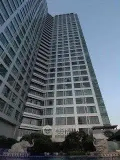 Stunning high-rise building exterior with modern architectural design and lush landscaping.