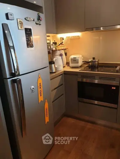 Modern kitchen with stainless steel fridge and built-in oven