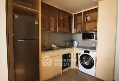 Modern kitchen with sleek appliances and ample storage in a stylish apartment.