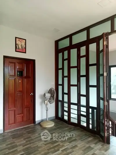 Spacious interior with wooden doors and modern decor, perfect for stylish living.