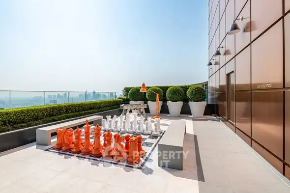 Luxurious rooftop terrace with giant chess set and stunning city views.
