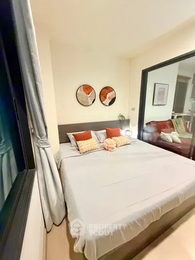 Cozy bedroom with modern decor and large window in stylish apartment