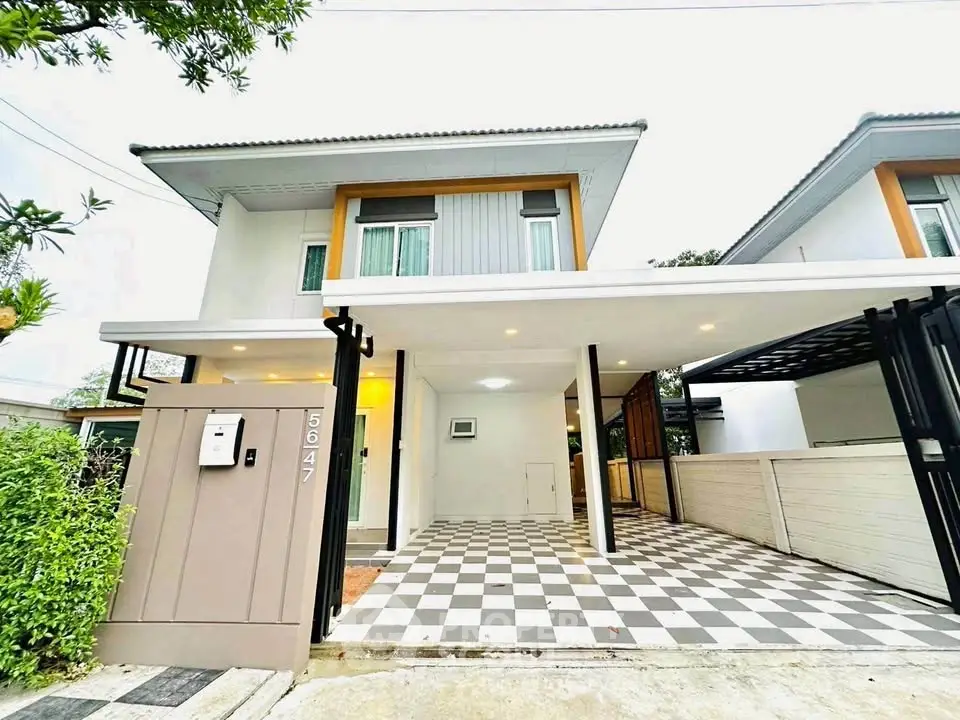 Modern two-story house with checkered driveway and sleek design