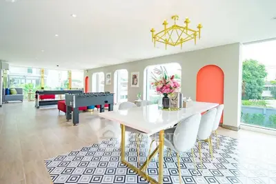 Luxurious open-plan living room with modern decor and vibrant accents