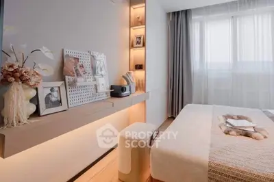 Elegant bedroom with modern decor and natural light, featuring cozy bed and stylish shelving.