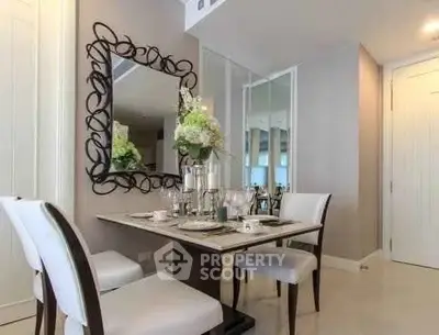 Elegant dining area with stylish mirror and modern decor