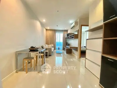 Modern living room with sleek furniture and bright natural lighting in a stylish apartment.