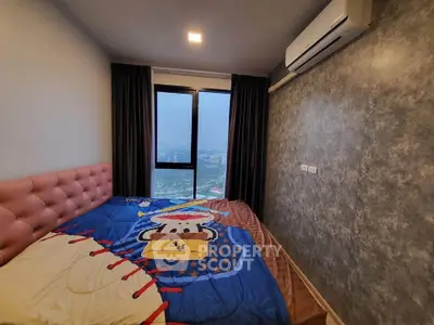 Cozy bedroom with city view, featuring modern decor and air conditioning.