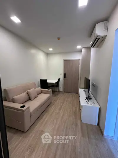 Modern living room with sleek furniture and air conditioning in a cozy apartment.