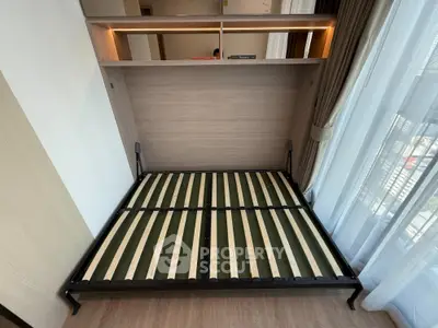 Modern studio apartment with foldable bed and large window for natural light