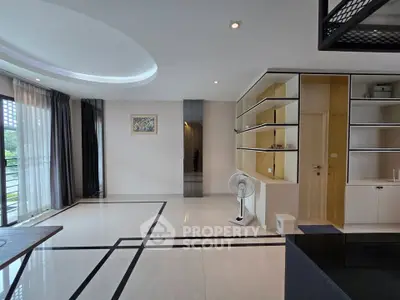 Spacious modern living room with elegant design and large windows offering natural light.
