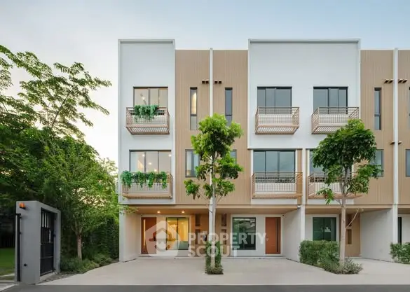 Modern townhouse exterior with lush greenery and spacious balconies