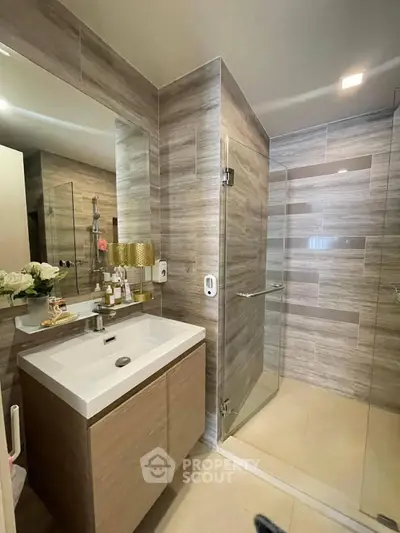 Modern bathroom with sleek design, glass shower, and stylish vanity in a contemporary home.