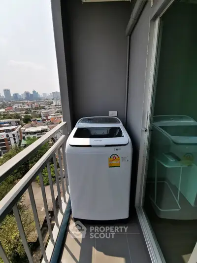 Modern balcony with washing machine and city view, perfect for urban living convenience.