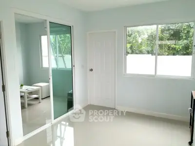 Bright and airy room with sliding glass doors and large windows, perfect for natural light lovers.