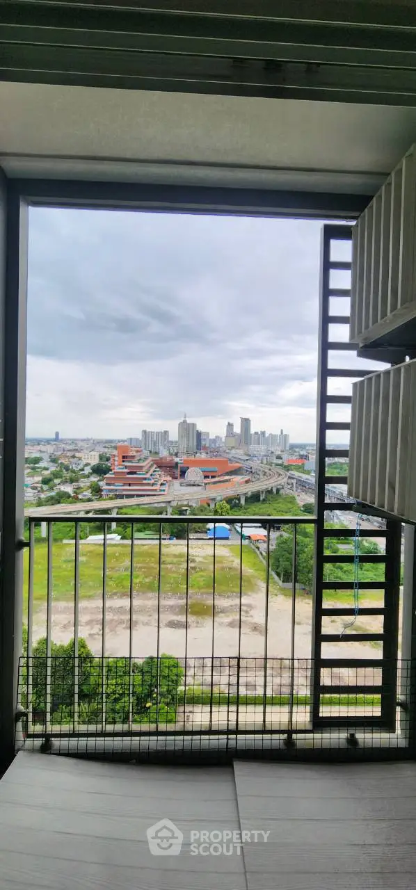 Stunning high-rise balcony view overlooking cityscape and green spaces, perfect for urban living.