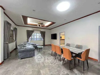 Spacious living room with modern dining area and elegant ceiling design