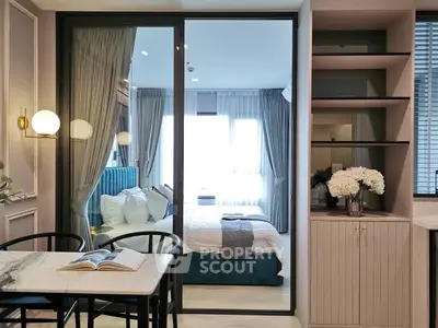 Modern bedroom with elegant decor and open layout, featuring a cozy bed and stylish furniture.