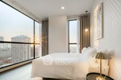 Luxurious bedroom with stunning city view and modern decor in high-rise apartment.