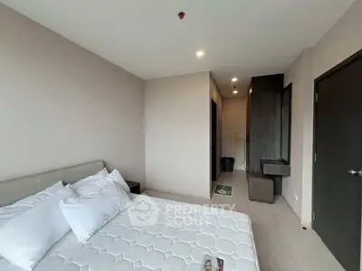 Modern bedroom with minimalist design and comfortable bed in a stylish apartment.