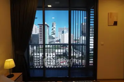 Modern apartment with city view from balcony, featuring sleek design and ample natural light.