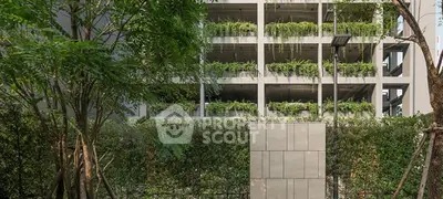 Modern building exterior with lush greenery and vertical garden design.
