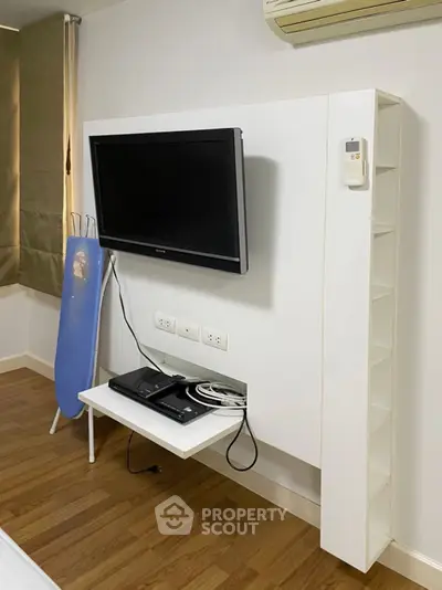 Modern bedroom with wall-mounted TV and sleek storage solutions