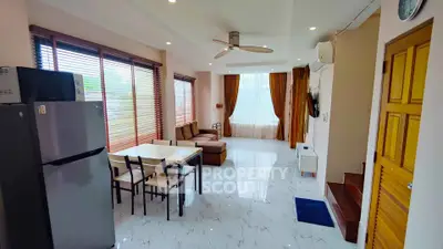 Spacious living room with modern furniture and large windows for natural light.