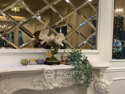 Elegant interior with decorative mirror and ornate mantelpiece in luxurious living space.