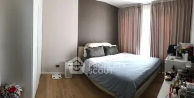 Cozy bedroom with modern decor and ample natural light