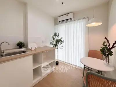Charming kitchen with open layout and cozy dining area, featuring modern decor and natural light.