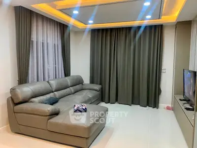 Modern living room with sleek leather sofa and ambient lighting