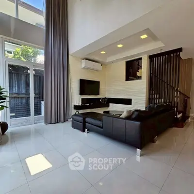 Spacious modern living room with high ceilings and sleek design