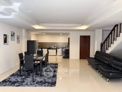 Spacious open-plan living and dining area with modern furniture and stylish decor.