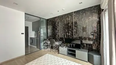 Modern studio apartment with stylish decor and open kitchen layout.